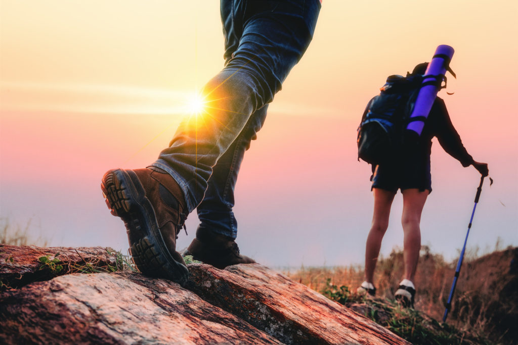 eco travel, eco experiences, sustainable travel,Young couple hiking in the forest during summer at sunset,travel,tourism and teamwork concept